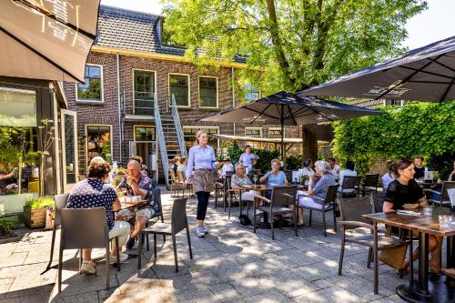 a group of people sitting at tables outside a restaurant at Broeck Oudewater in Oudewater