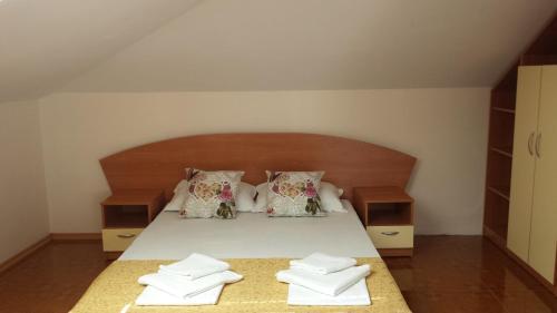 a bedroom with a bed with two towels on it at Villa Diana in Sozopol