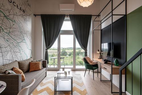 a living room with a couch and a tv at RentPlanet - Apartamenty Zarembowicza II in Wrocław