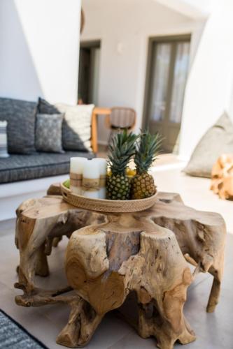 a coffee table made out of a tree stump in a living room at Arsenis Luxury Villas in Plaka