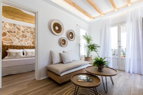 a bedroom with a bed and two tables at Arsenis Luxury Villas in Plaka
