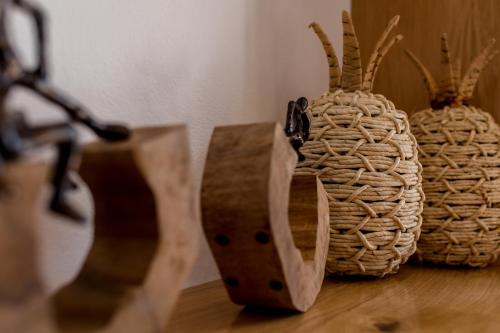a group of baskets sitting on top of a wooden table at Arsenis Luxury Villas in Plaka