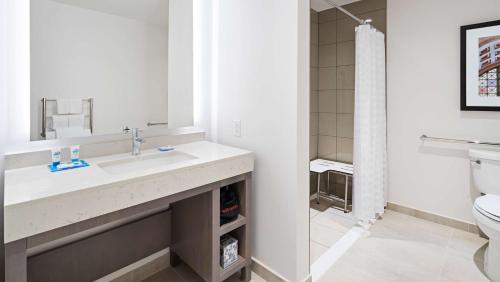 a bathroom with a sink and a toilet at Hyatt House Washington DC/The Wharf in Washington