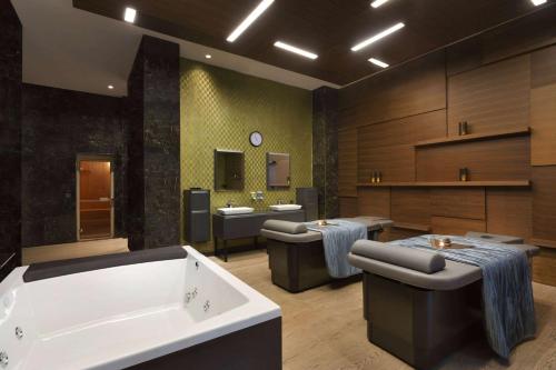 a large bathroom with two sinks and a tub at Wyndham Grand Istanbul Levent Hotel & Conference Center in Istanbul