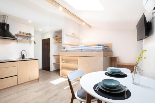 a small apartment with a table and chairs and a bed at Apartments Nautilus, nearby beach Svetilnik in Izola