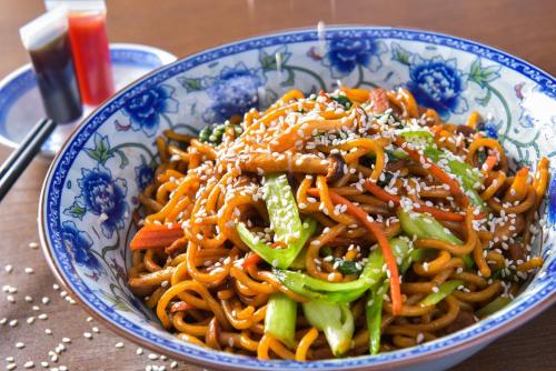 a blue and white bowl of food with noodles at Holiday Inn Foshan Nanhai Central by IHG in Foshan