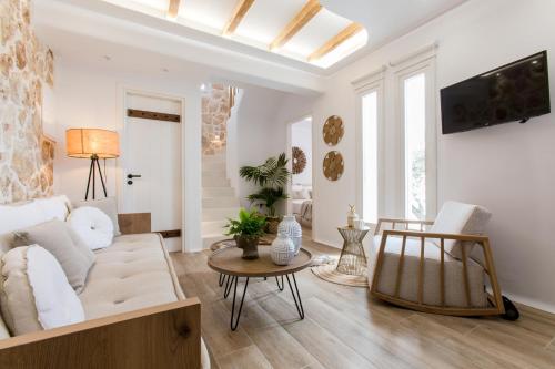 a living room with a couch and a table at Arsenis Luxury Villas in Plaka