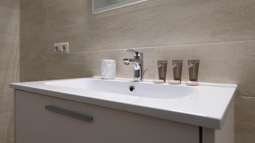 a white sink in a bathroom with a mirror at Italianway - Villa Tola in Valdisotto