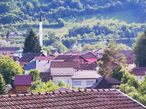 a group of houses in a town with a tower at Unaqua Apartments in Kulen Vakuf