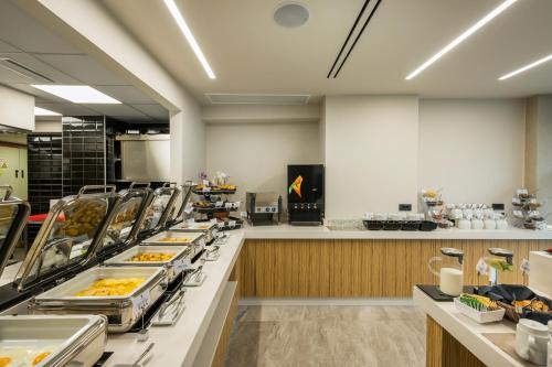 a buffet line with many plates of food at Hyperion City Hotel & Spa in Chania Town