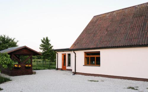 a white house with a brown roof at Pühajõe Holiday Park in Pühajõe