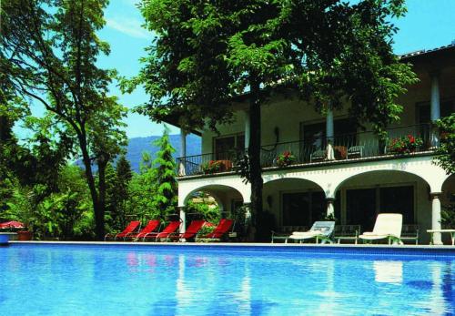 una casa con sedie e una piscina di Villa Olevano ad Ascona
