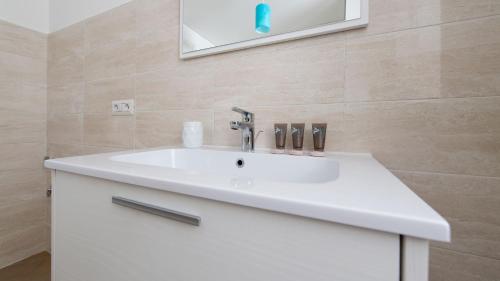 a bathroom with a white sink and a mirror at Italianway - Villa Tola in Valdisotto