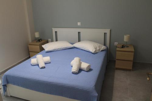 a bedroom with a bed with towels on it at Chloe Apartments in Tsoukaladhes