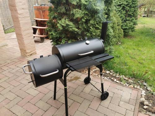 a bbq grill sitting on top of a bench at Katica Vendégház Somogyvár - Ladybird Villa Somogyvár in Somogyvár