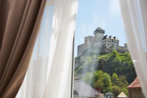 a view of a castle from a window at Penzión Branecky in Trenčín