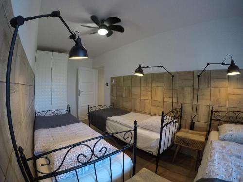 a bedroom with two beds and a ceiling fan at ApartHotel Gdanska14 in Krynica Morska
