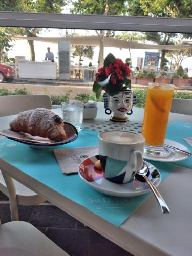 a table with a plate of food and a cup of coffee at BeB Palazzo Mancini in Minori