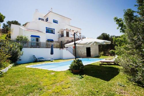 a villa with a swimming pool in front of a house at LUMINIAN Big Modern Villa with outstanding views sea & countryside in Mijas