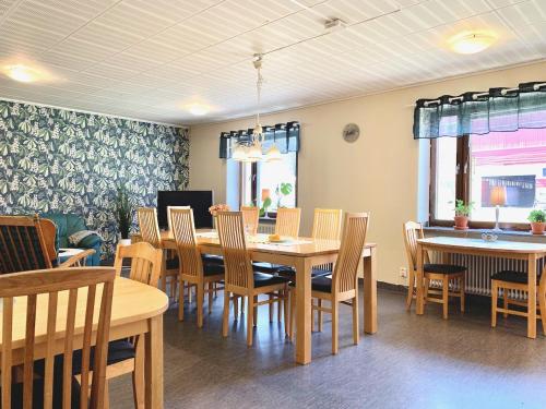 a dining room with a table and chairs at Tornedalens B&B in Övertorneå
