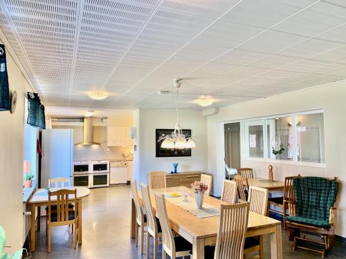 a kitchen and dining room with a table and chairs at Tornedalens B&B in Övertorneå