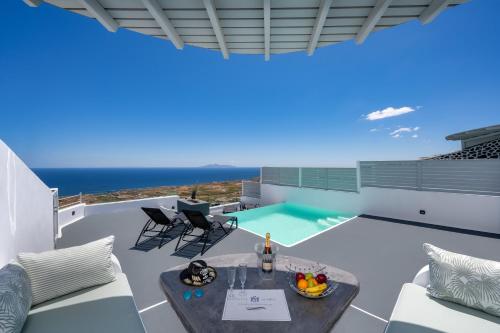 a view from the balcony of a house with a swimming pool at Siete Mares Luxury Suites in Imerovigli