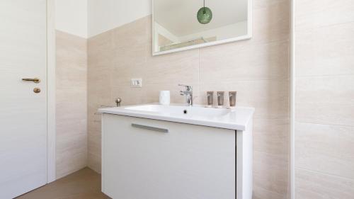 a bathroom with a white sink and a mirror at Italianway - Villa Tola in Valdisotto