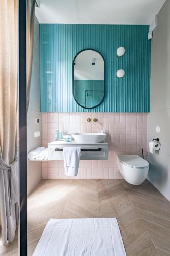 a bathroom with a tub and a sink and a mirror at Aqua Your Stay in Sasino