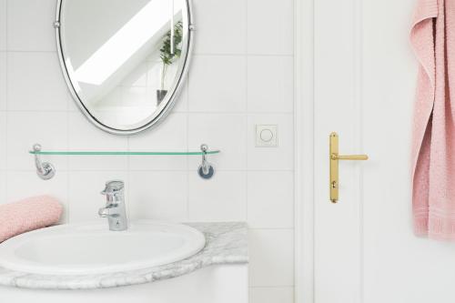 a bathroom with a sink and a mirror at Villa Lieboch in Lieboch