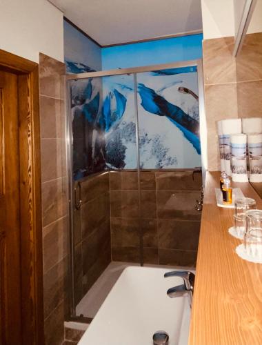 a bathroom with a shower with a sink at Luční bouda in Pec pod Sněžkou