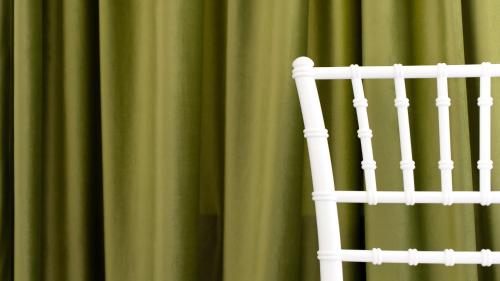 a white chair in front of a green curtain at Italianway - Villa Tola in Valdisotto