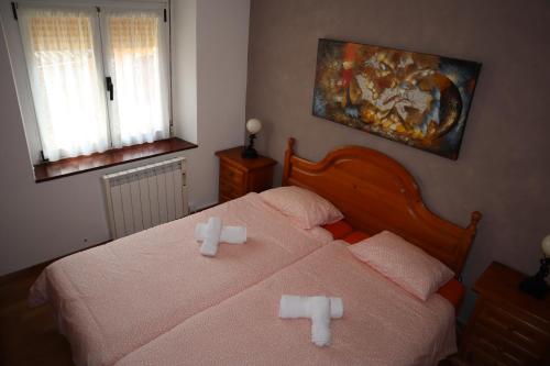 a bedroom with two beds with crosses on them at Casa Rural Cares in Santa Maria de Valdeón