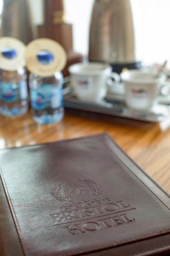 a brown passport sitting on top of a wooden table at Bristol Hotel in Amman