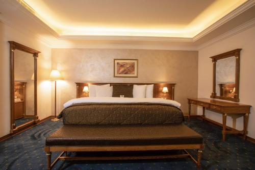 
a bedroom with a large bed and a large window at Bristol Hotel in Amman
