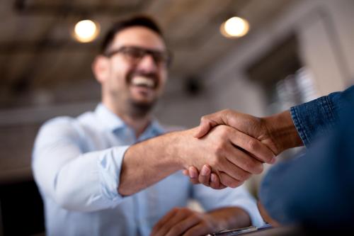 a man shaking hands with another man at Up Hotel Budapest in Budapest