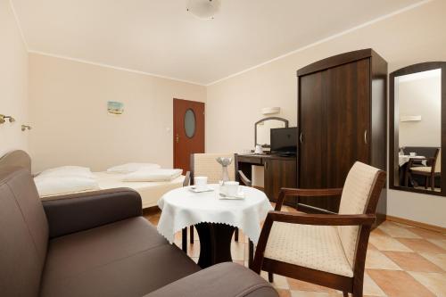 a living room with a couch and a table at Holiday House Europa in Rewal