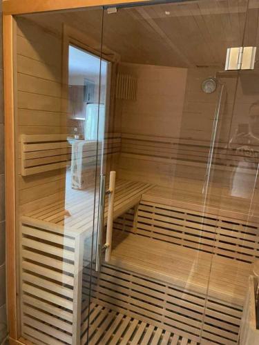 a sauna with a glass door in a room at Luxurious 6 bedroom villa with a private pool in Chalkida