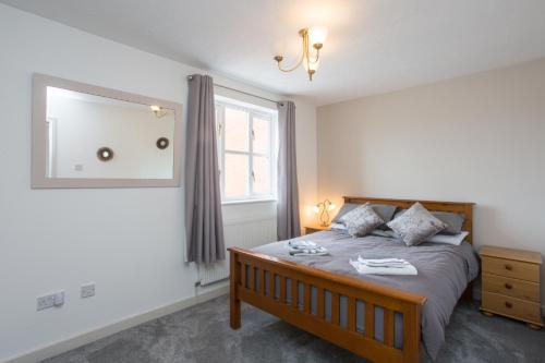 a bedroom with a bed and a large window at Rocester Roost in Rocester