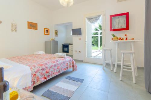 a bedroom with a bed and a table and chairs at Tenuta Don Carmelo in Lecce