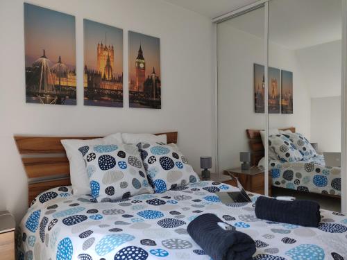 a bedroom with a bed with blue and white pillows at Appart'HomeCity - Rouen Lessard in Rouen