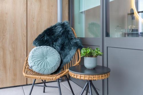 a pillow sitting on a chair next to a table at Van der Valk Hotel Venlo in Venlo