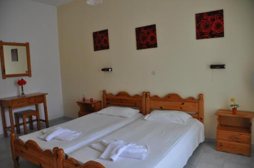 a bedroom with a large bed with towels on it at Villa Vasiliki in Vitalades