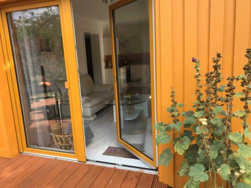 a sliding glass door of a house with a couch at Ferienhaus Eldena Greifswald Steffi Fasten in Eldena