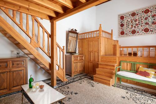 a room with a staircase and a bed and a table at Villa Lindia in Líndos