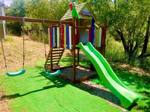 a playground with a slide and a play house at Cuore Della Valle in Cefalù