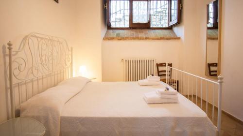 a bedroom with a white bed with towels on it at Borgo Majella by Rentbeat in Abbateggio
