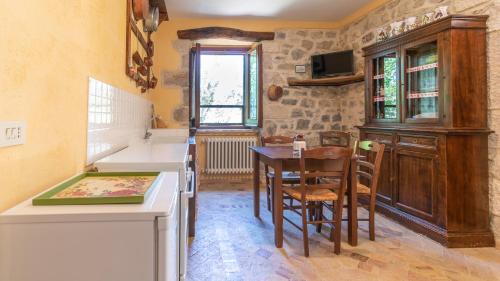 a kitchen and dining room with a table and chairs at Borgo Majella by Rentbeat in Abbateggio