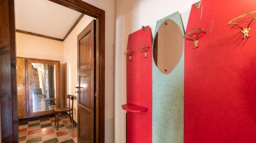 a red refrigerator in a room with a door at Borgo Majella by Rentbeat in Abbateggio