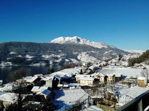 a town covered in snow with a mountain in the background at Numero 53 Tenna OSPITAR in Tenna 