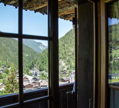 a view from a window of a mountain view at La Ferme in La Clusaz